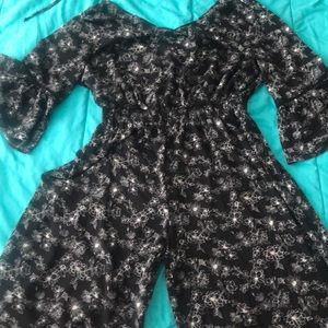 Black jumpsuit with white floral print.
